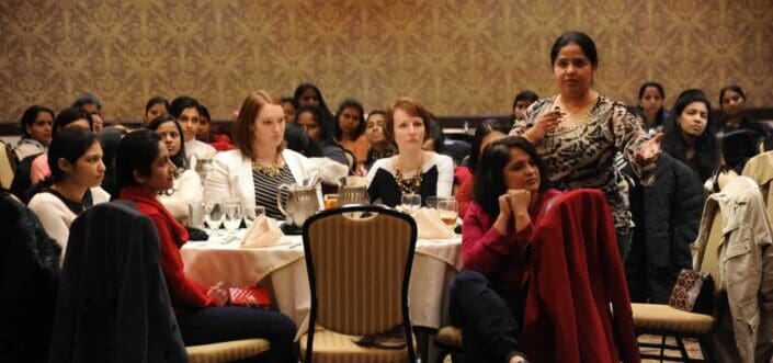 Indian woman discussing over something with a group of other women