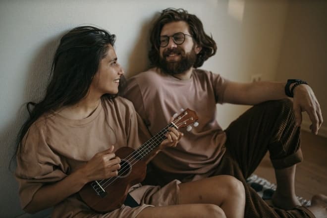 woman playing the ukulele for a man - creative date ideas