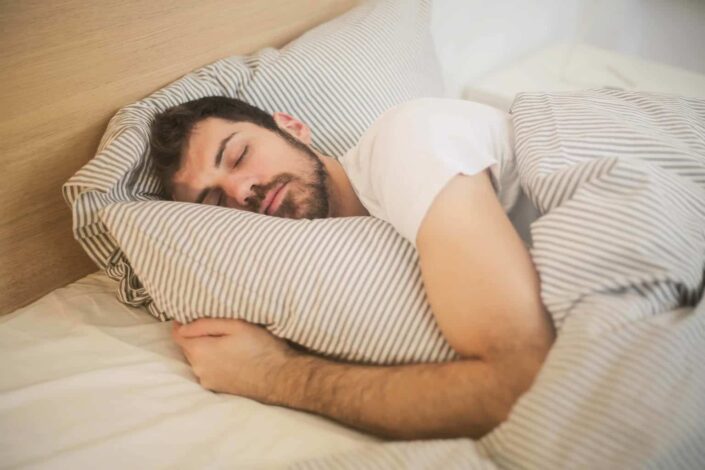 Man comfortably sleeping in his bed