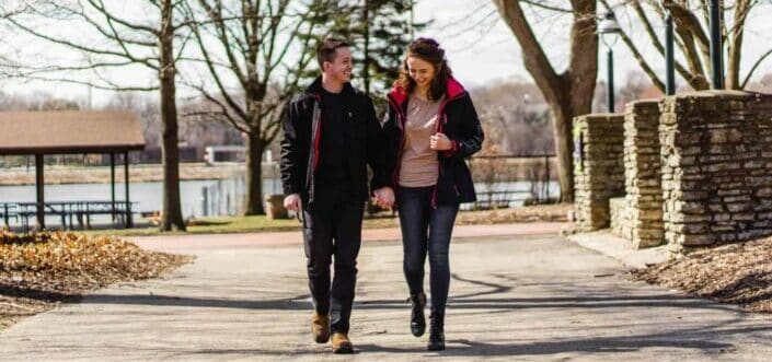 Couple holding hands while walking.