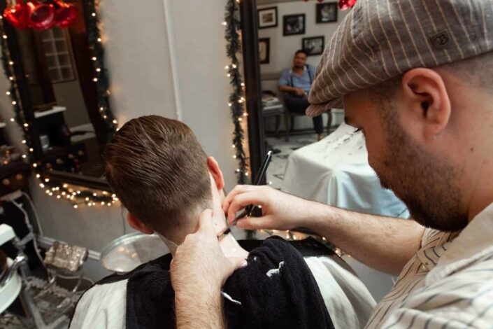 Guy giving boy a haircut