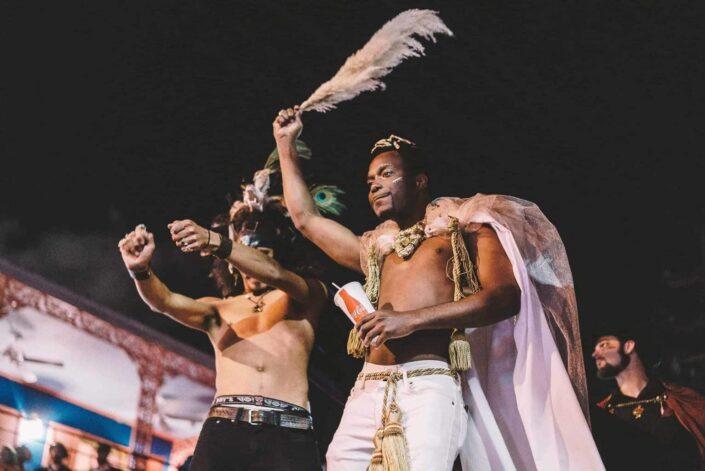 Two costumed guys dancing together.