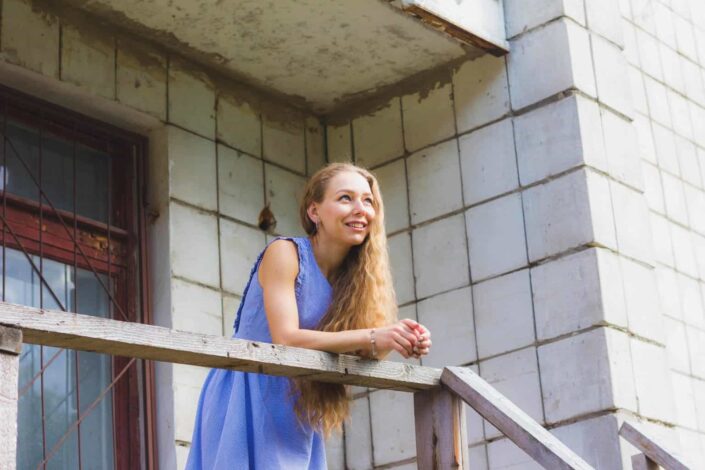 Girl standing on the balcony smiling