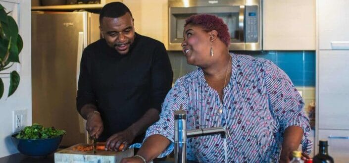 Couple having fun at a kitchen while preparing food