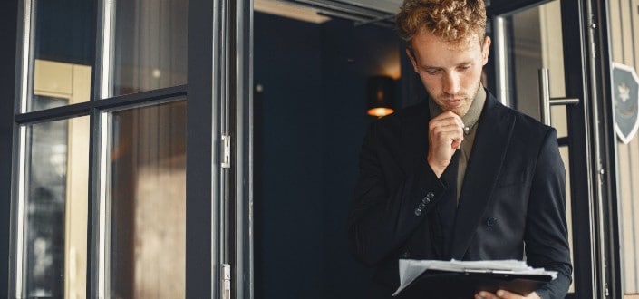 man wearing a suit while reading
