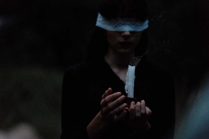 blindfolded woman levitating object