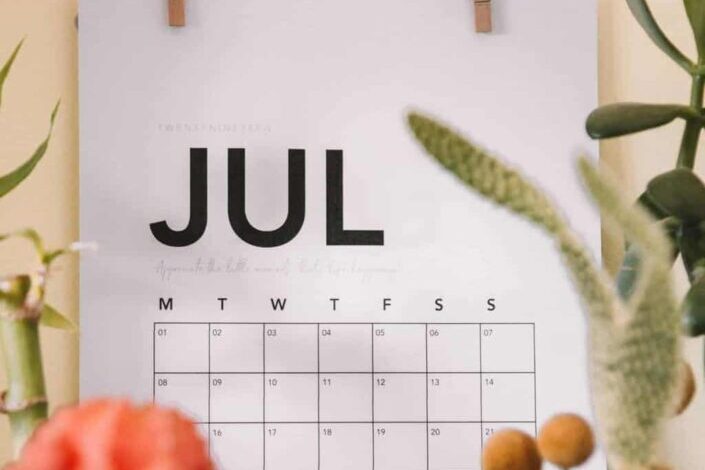 july calendar in front of plants
