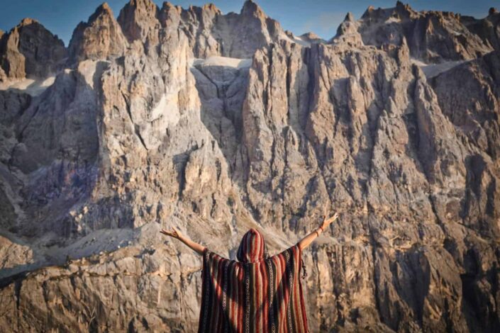 person spreading arms in front of mountains