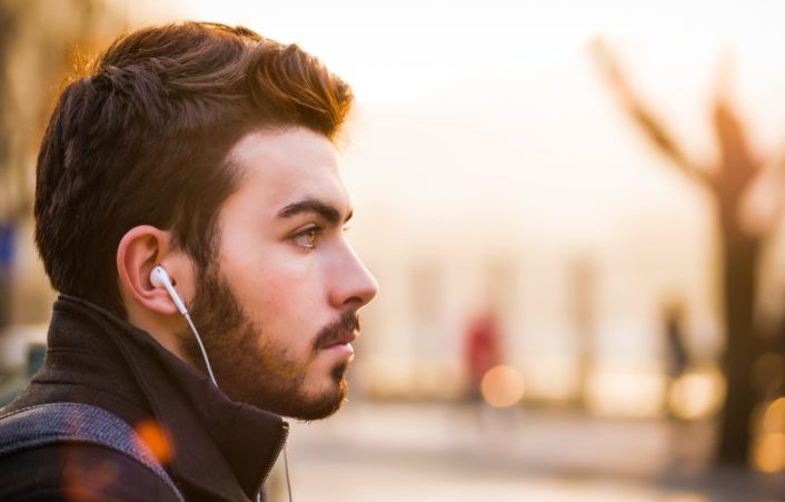 man listening to music with his earphones