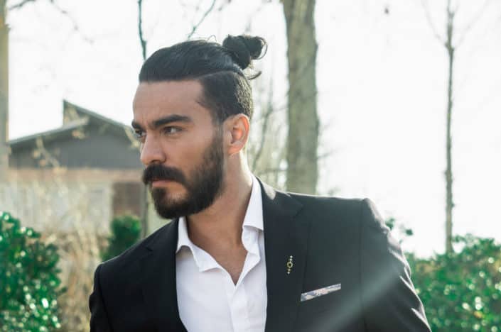 man in a suit with a man bun