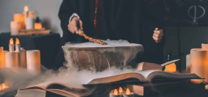 wizard brewing in cauldron near candles