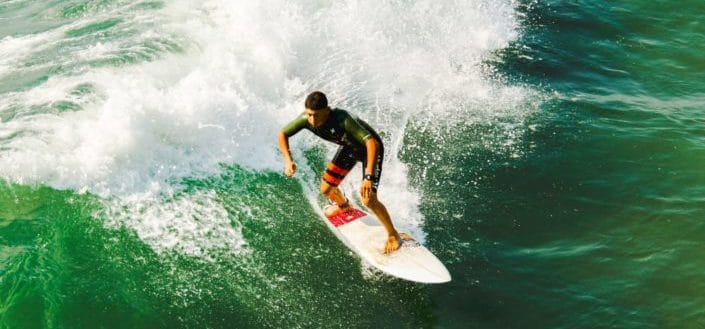 Man surfing through the waves.