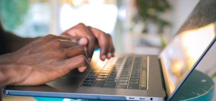 person using silver laptop computer