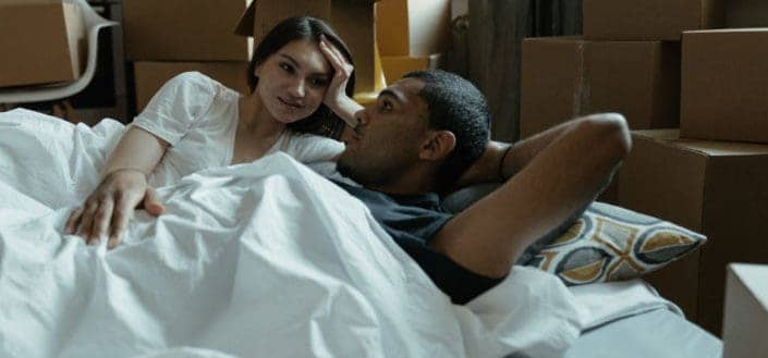 Couple talking in bed