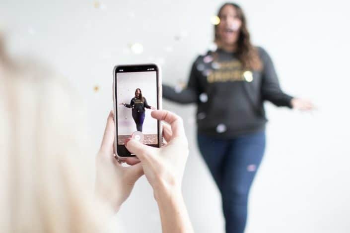 Woman taking a photo of her friend