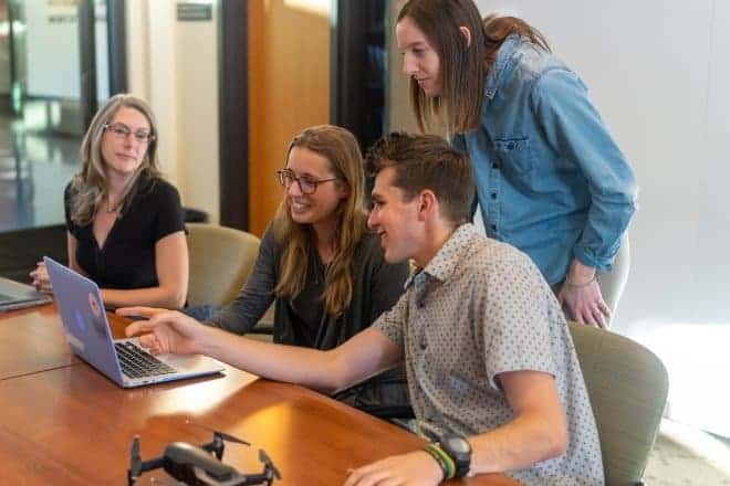 Office workers discussing something - Trivia Questions for Teens