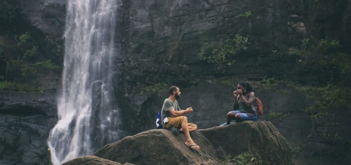 Couple enjoying nature beside a falls.
