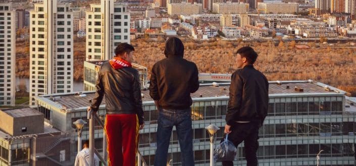 Men standing on top of building