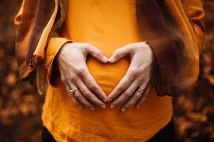 Pregnant woman with a heart on her belly