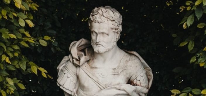 A white ancient Rome statue hidden in the bush
