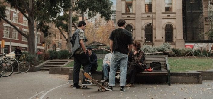 male teenagers on bench talking