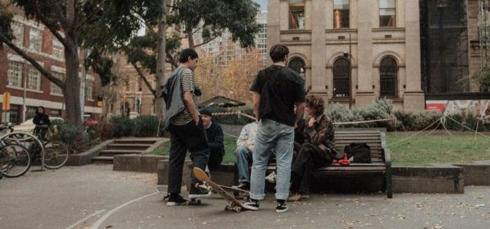 male teenagers on bench talking 