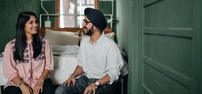 Indian man and woman having a light conversation in a room