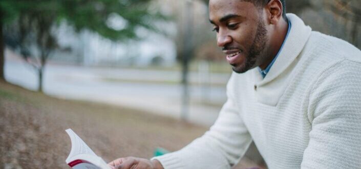 Man delightfully reading a book.