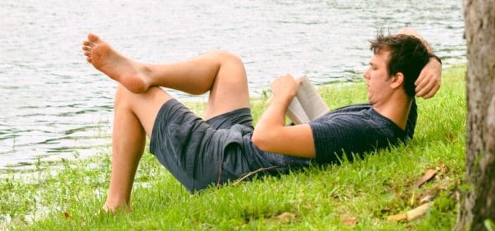 Man laying while reading