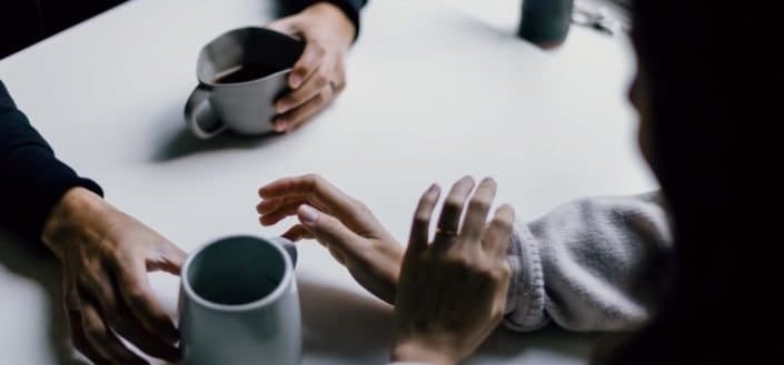 Two people drinking coffee together