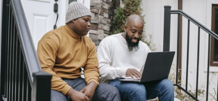 men sitting while browsing on the internet