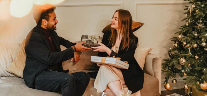 man and woman exchanging gifts