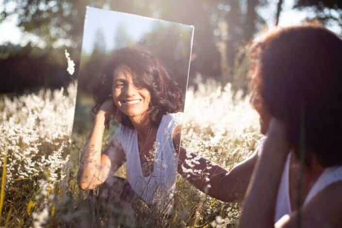 woman admiring her reflection in the mirror