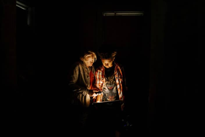 couple watching something on iPad in dark room