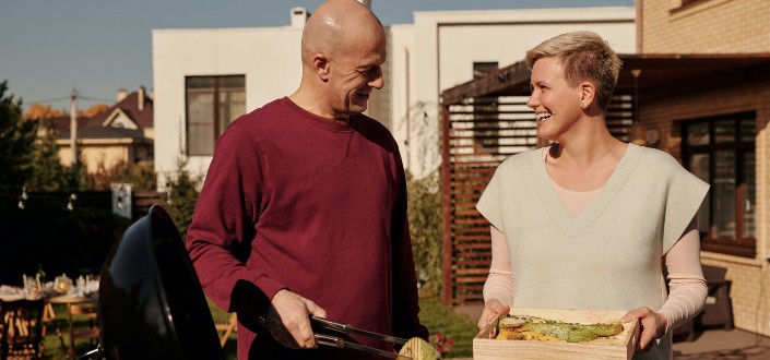 adult couple preparing an outdoor barbecue meal 