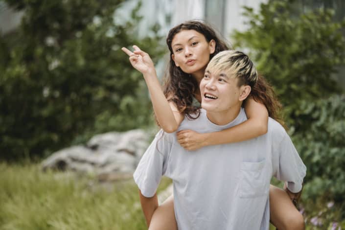 man carrying he girl on his back 