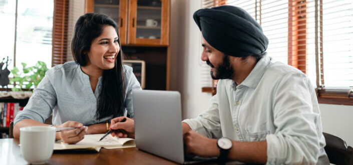 Workmates happily working together on the table.