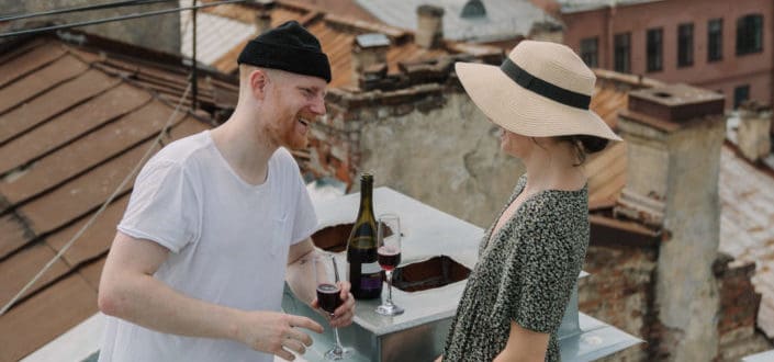 couple enjoying glass of wine in the rooftop