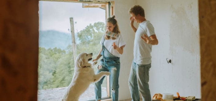 couple playing with their cute dog