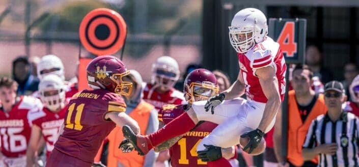 football player being lifted up by another player