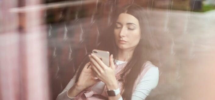 Girl reading a text on her phone.