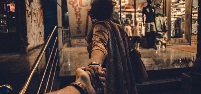 person holding another person standing near the stairs