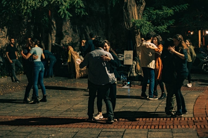 people dancing with their partners in an open area