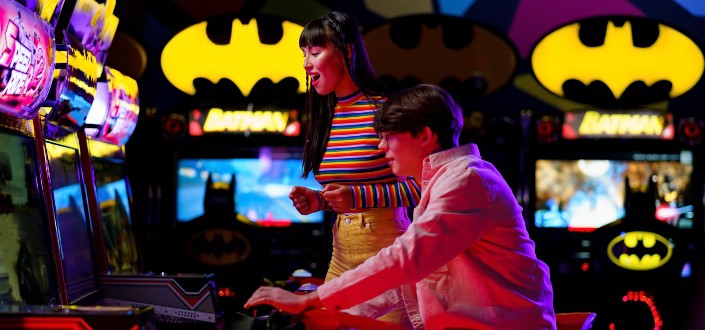 happy man and woman playing at an arcade