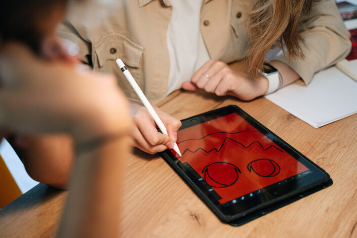 Woman sketching on a tablet.