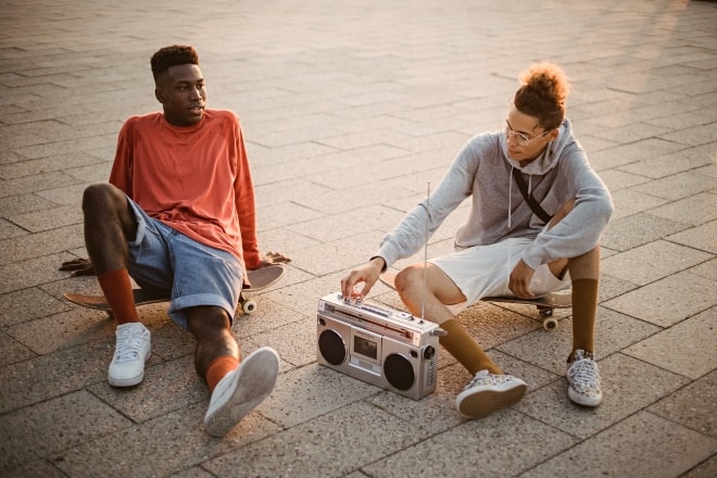Two men sitting on the floor listening to the radio - radio trivia