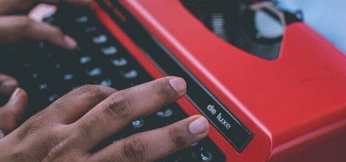 hands typing on typewriter