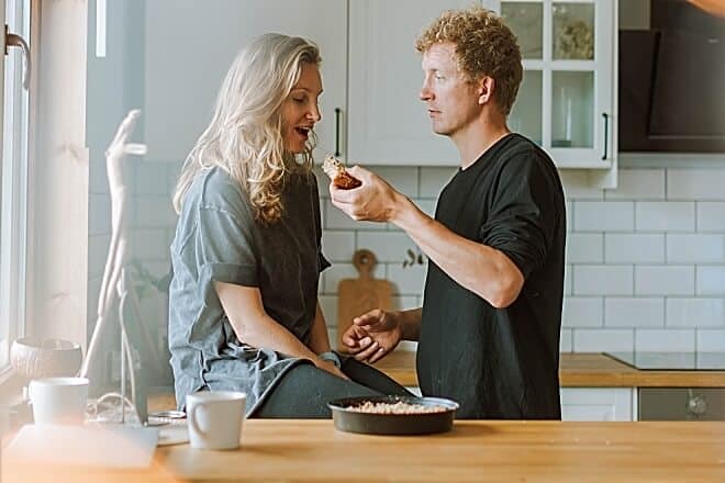 man feeding his girl for breakfast - Romantic Things To Do