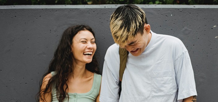 a woman laughing with a guy