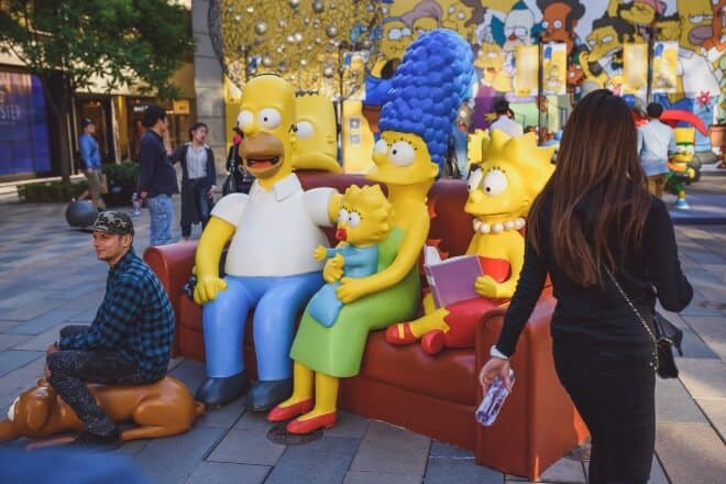 Man posing with Simpsons statue - Simpsons Trivia 